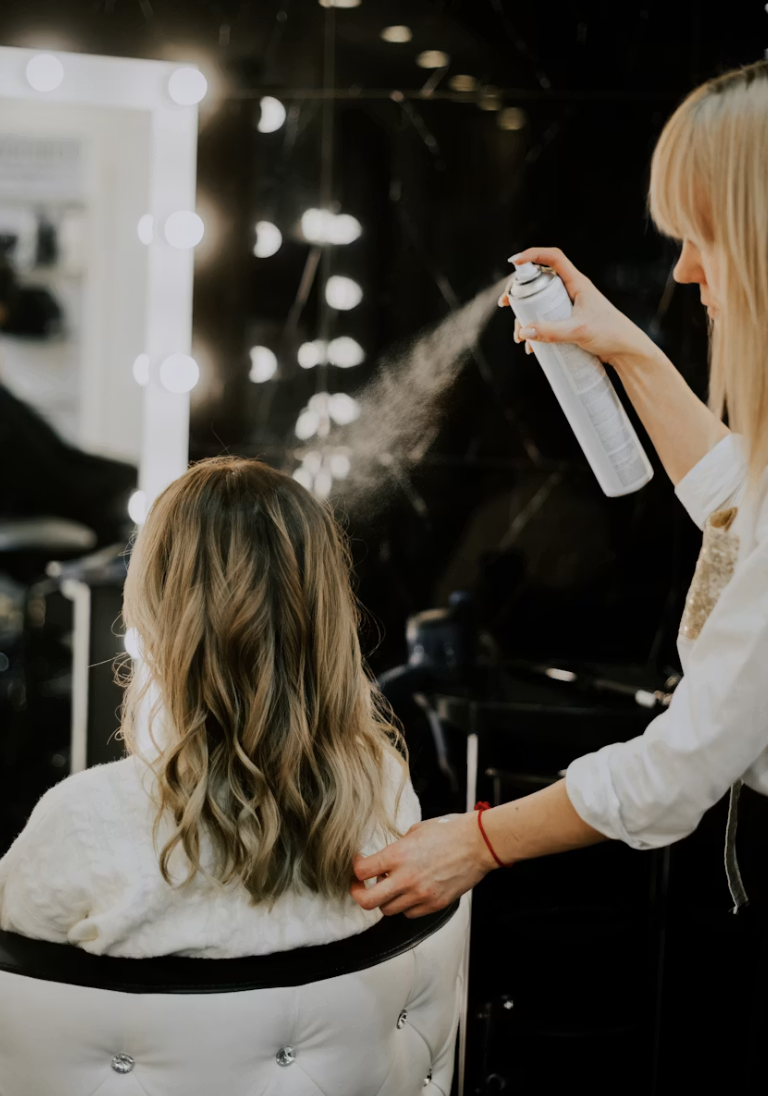 A stylist finishing a client’s style at Mirrors Hair Salon in downtown Calgary
